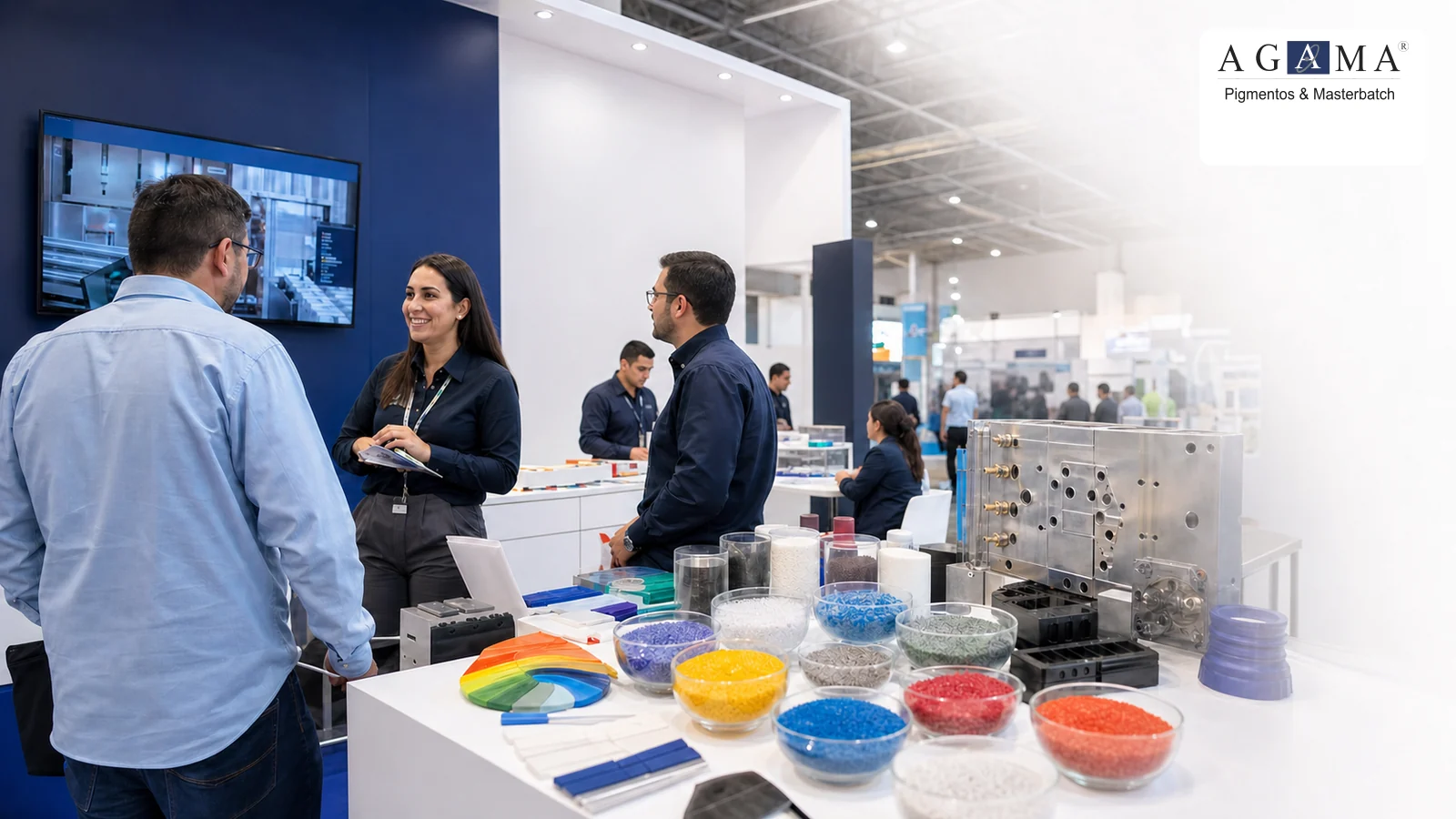 Equipo técnico y visitantes junto a muestras de color para plástico en Meximold
